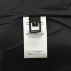 Black jacket care label tag showing 100% cotton and size details
