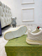 Gucci unisex sneakers outsole view, textured tread and tan rubber sole with logo mark