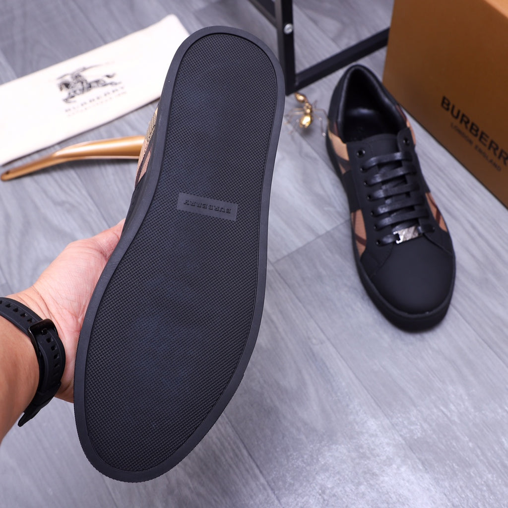 Burberry sneaker outsole view, dark textured sole with lace-up shoe in background
