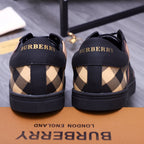 Burberry sneakers back view, black heel tabs with Burberry lettering and check uppers