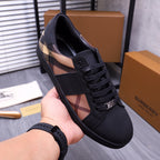 Burberry lace-up sneaker shown in hand, black upper with check stripe panel