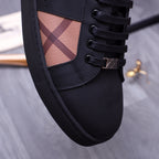 Burberry sneaker detail: black laces, check fabric insert on side, stitched panel edges