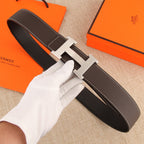 Hermes leather belt with dark brown strap and gold-tone H buckle, white contrast stitching