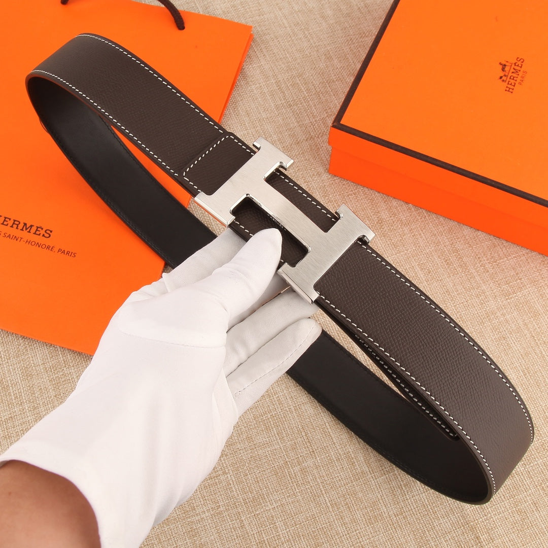 Hermes leather belt with dark brown strap and gold-tone H buckle, white contrast stitching