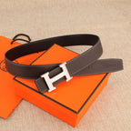 Leather belt with gold-tone H buckle, rectangular keeper, and white contrast stitching