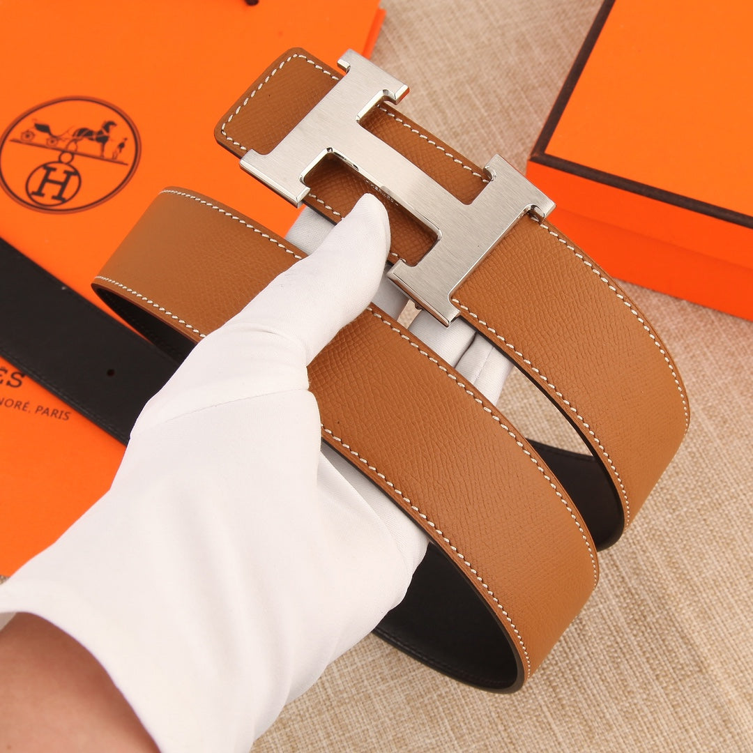 Hermès belt with tan leather strap, silver buckle, and stitched keeper strap