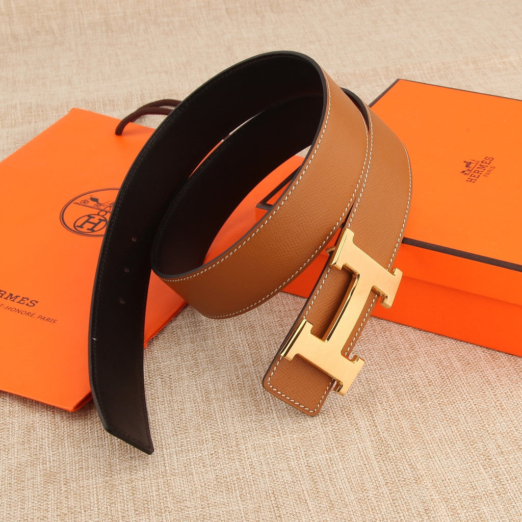 Hermès belt, tan exterior and dark underside, with silver buckle and stitched trim