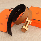 Hermès belt, tan exterior and dark underside, with silver buckle and stitched trim