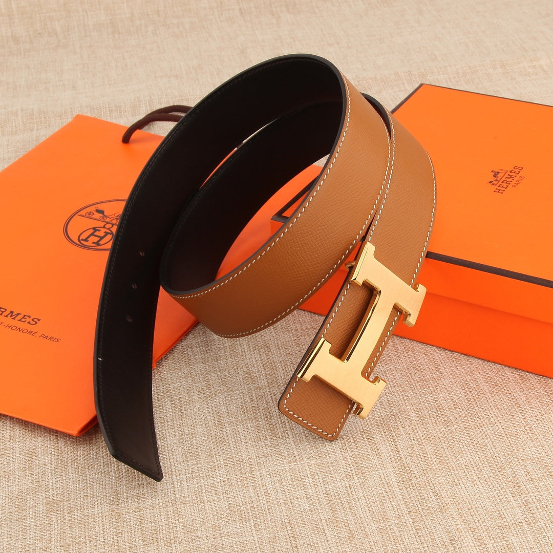 Hermès belt, tan exterior and dark underside, with silver buckle and stitched trim