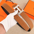 Hermès belt with tan leather strap, silver buckle, and visible adjustment holes