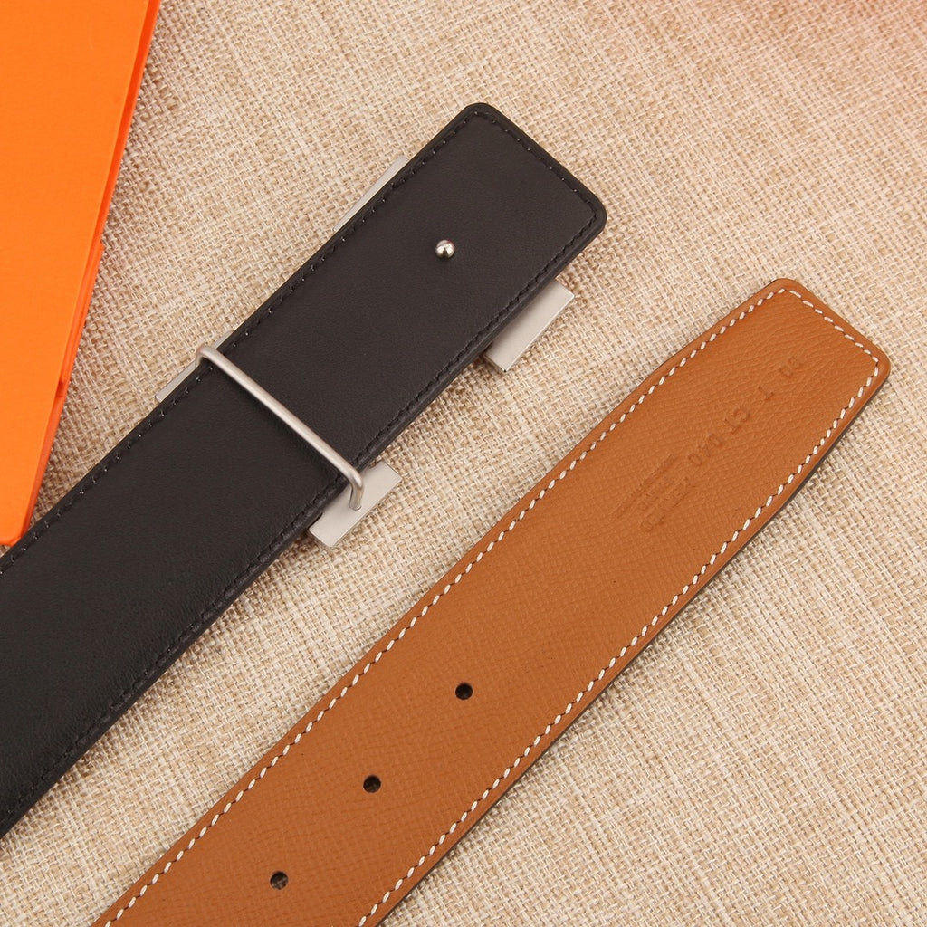 Hermès belt straps in black and tan leather with adjustment holes and metal bar