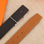Hermès belt straps in black and tan leather with adjustment holes and metal bar
