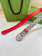 Red leather belt strap with GG patterned underside and silver-tone double G buckle