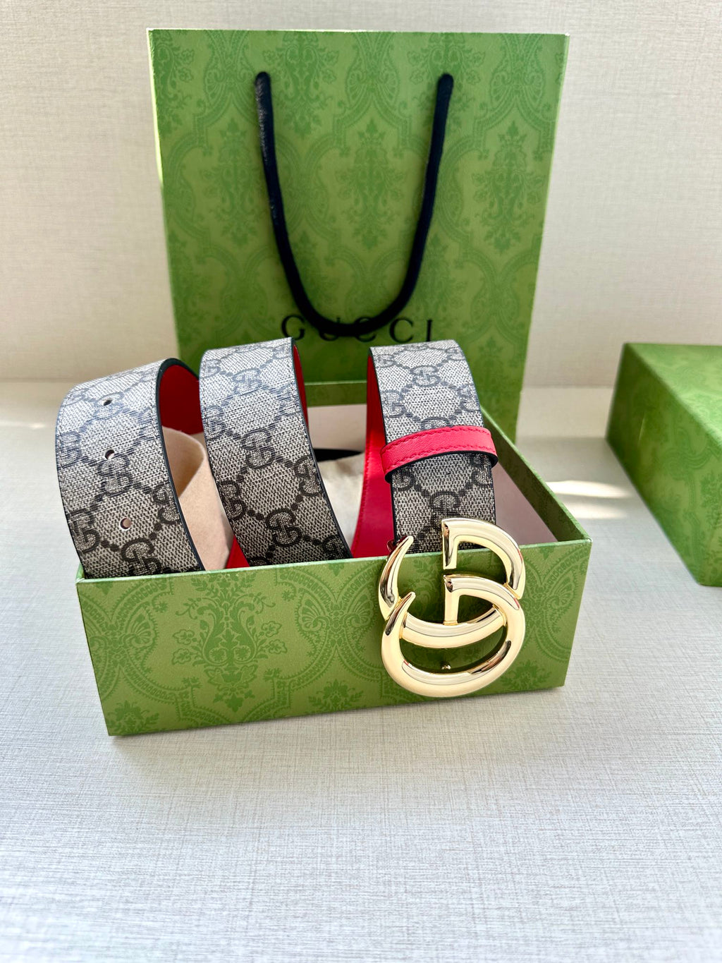 GG canvas belt with red leather center stripe and gold-tone interlocking G buckle