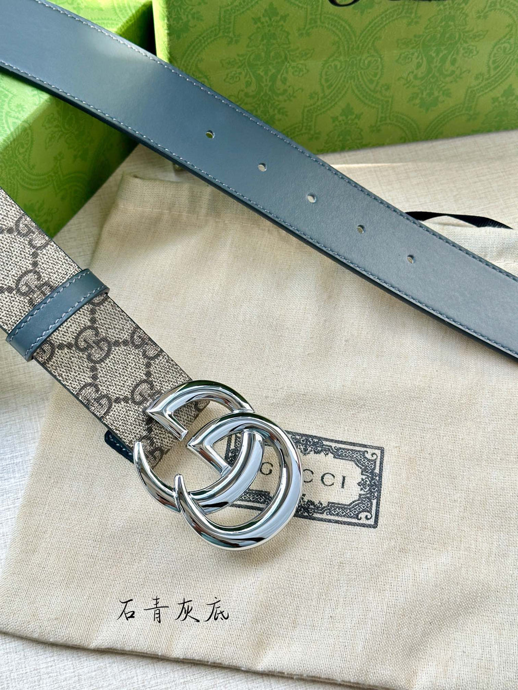 Gucci belt detail of blue leather strap with round grommets and silver-tone buckle ring