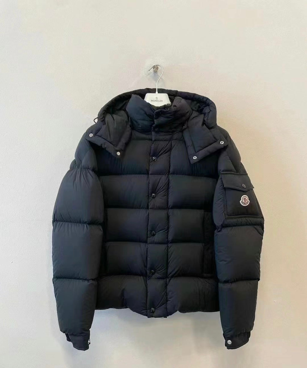 Long puffer jacket in dark color, full front button closure and hood
