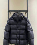 Long puffer jacket in dark color, hood with drawstrings, front zip and buttons