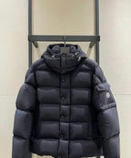 Long puffer jacket in dark color, hood with drawstrings, front zip and buttons