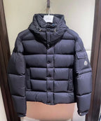 Long puffer jacket in dark color, hooded collar and quilted front panel