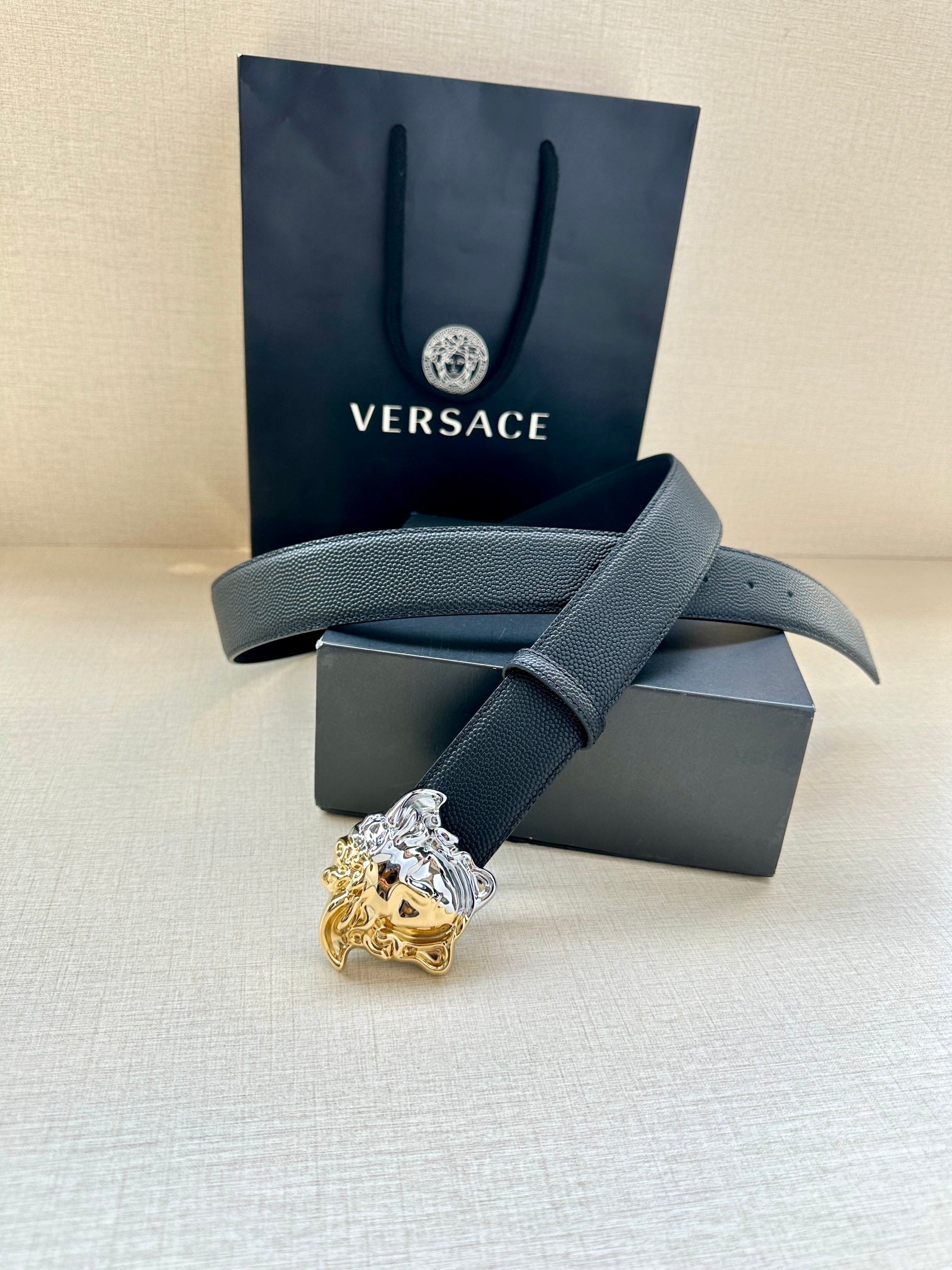 Versace blue leather belt with silver-and-gold Medusa crest buckle