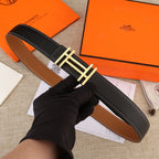 Black leather belt with gold-tone H buckle and contrast white stitching