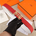 Red leather belt with gold H-style buckle and white contrast stitching.