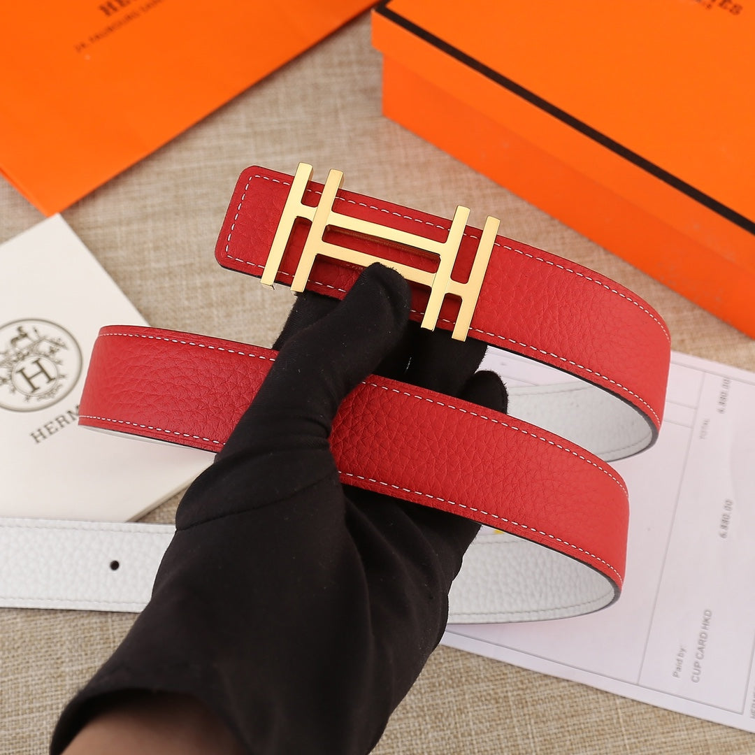Red leather belt with gold H buckle on a stitched strap, shown top view.