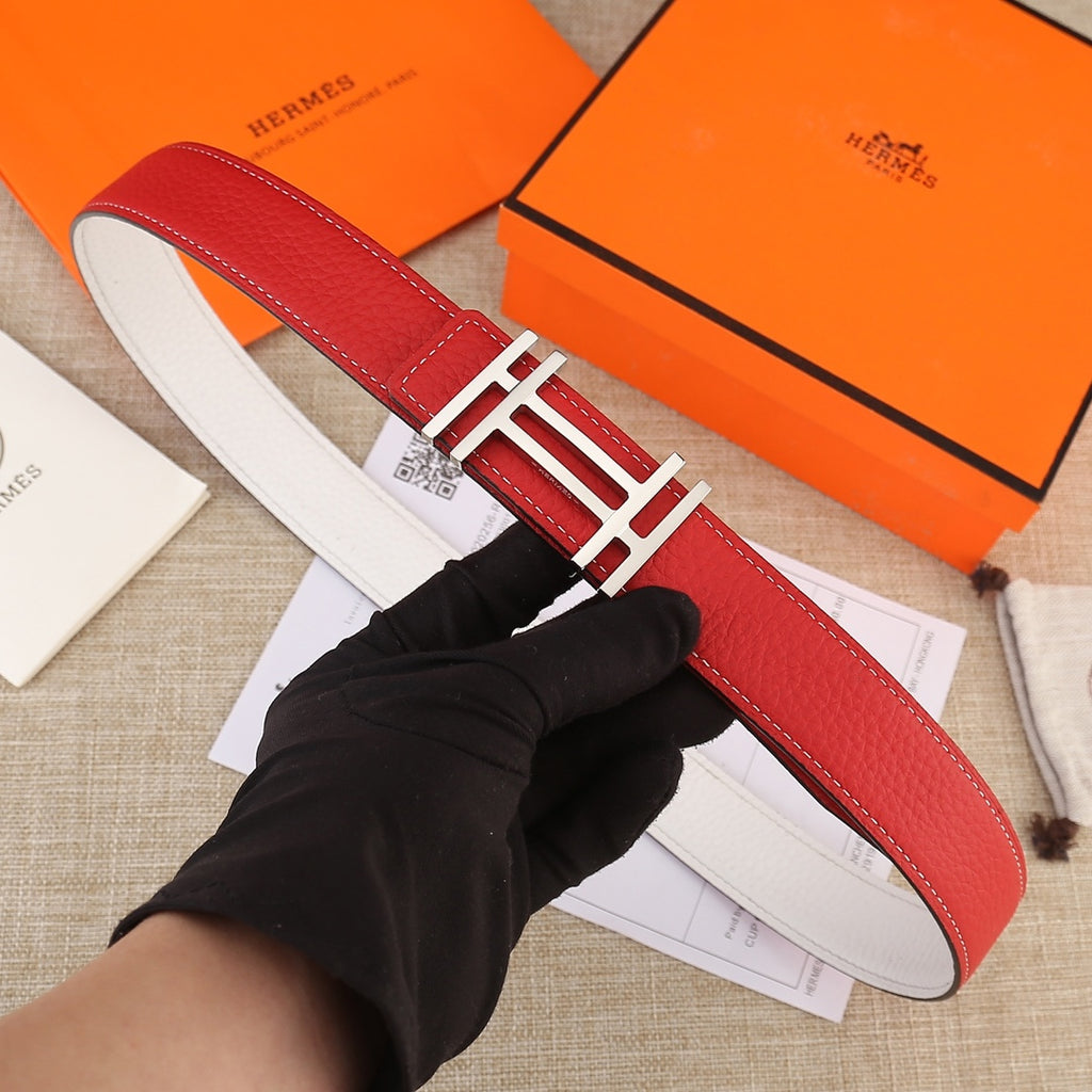 Red leather belt with gold H buckle and white contrast stitching, full strap view.