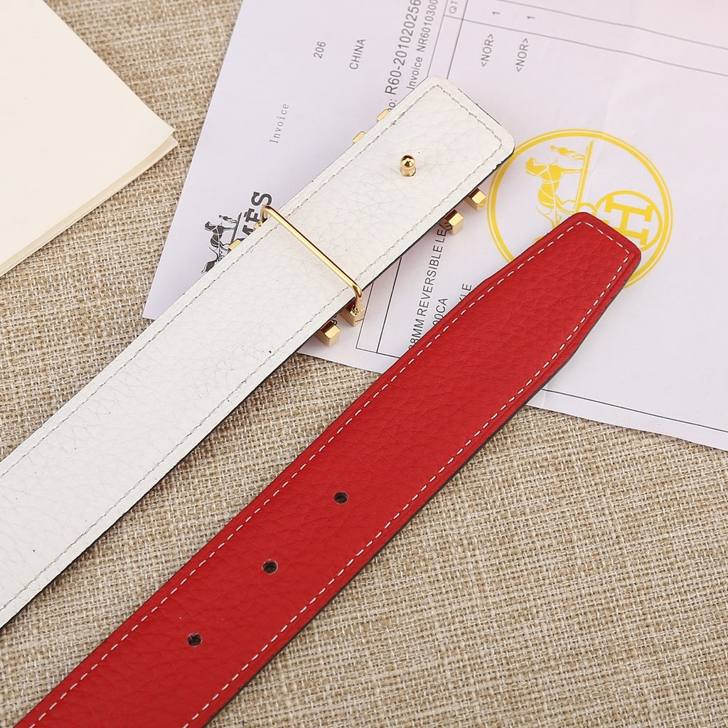 Red leather belt with silver-toned buckle; visible row of punched sizing holes.