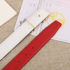 Red leather belt with silver-toned buckle; visible row of punched sizing holes.