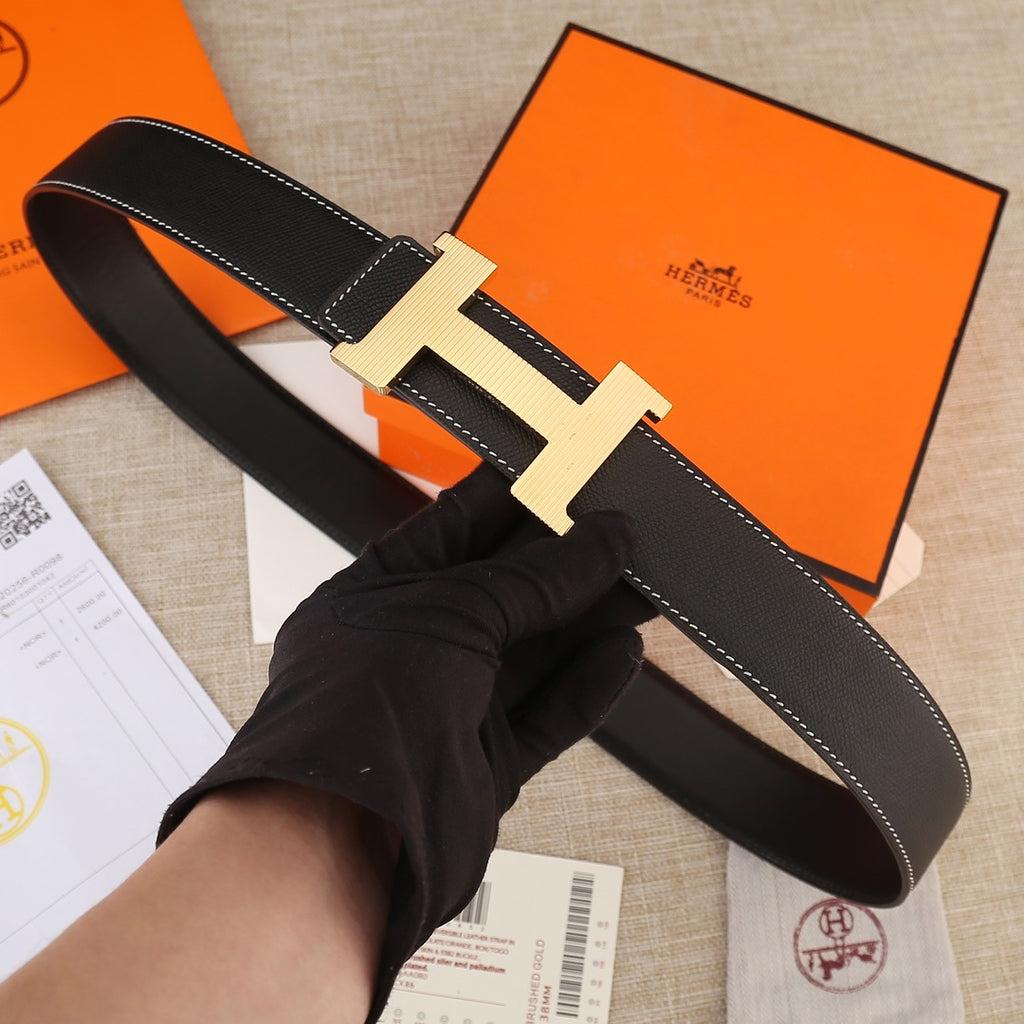 Black leather belt with textured gold H buckle and contrast white stitching