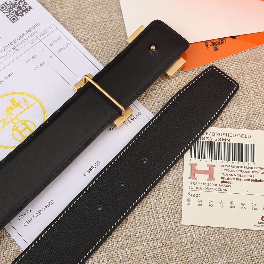Black leather belt strap with gold buckle plate, eyelets, and white stitching