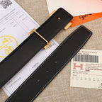 Black leather belt strap with gold buckle plate, eyelets, and white stitching