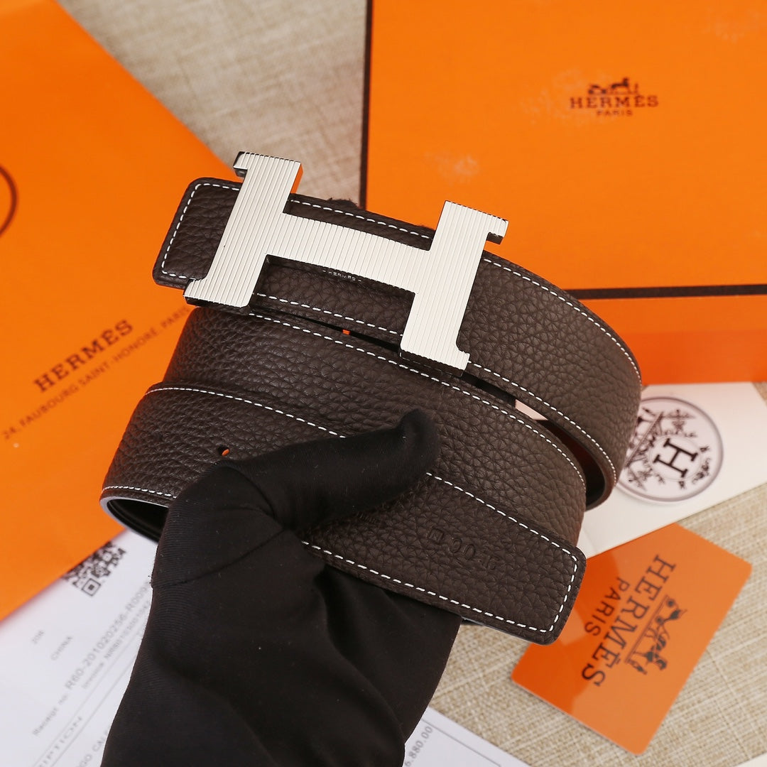 Leather belt with H buckle on dark brown textured strap, visible stitching detail.