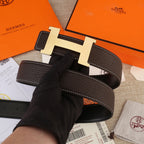 Leather belt and H buckle, dark brown strap with white-stitched edge detailing.