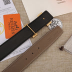 Hermes belt with black leather strap, gold-tone buckle, and brown leather strap detail
