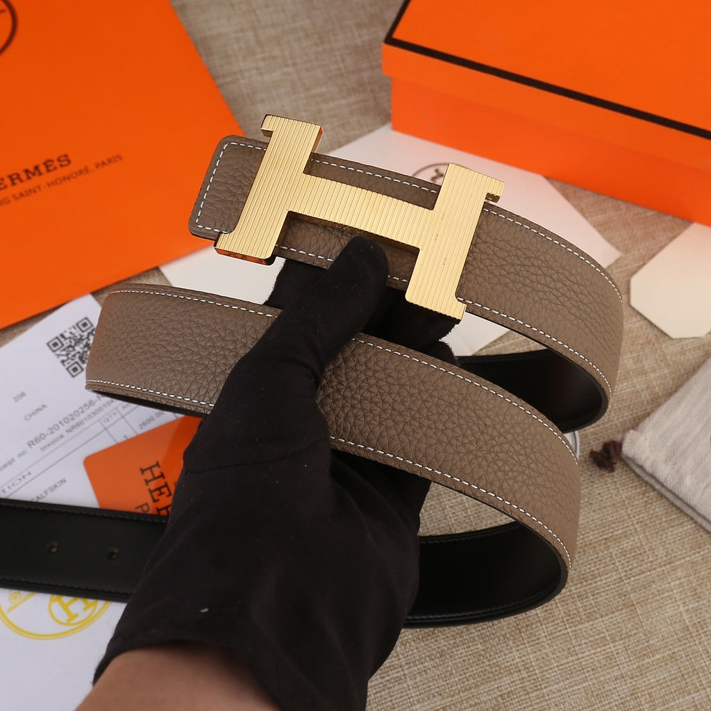 Hermes belt with brown leather strap and silver-tone H buckle over black lining