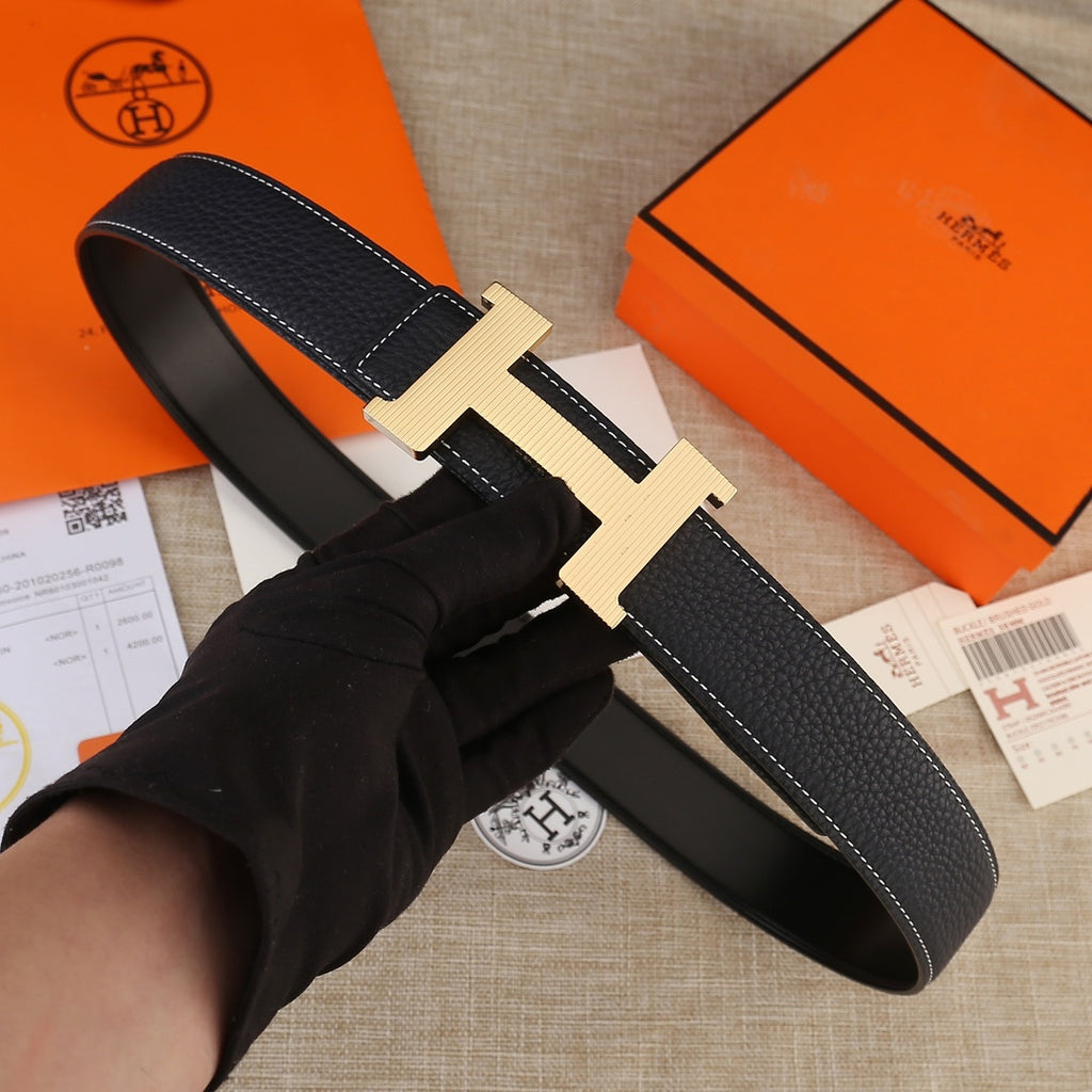 Hermes black leather belt with light gold H buckle and white contrast stitching along edge.