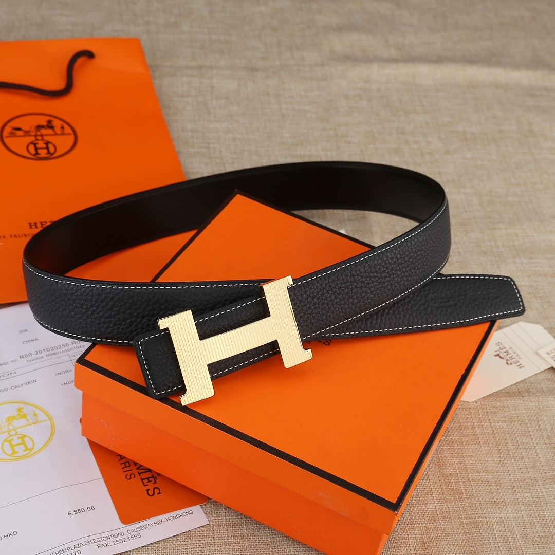 Hermes black leather belt with light gold H buckle, worn-in loop, and contrast stitching.