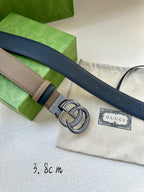 Gucci belt with beige strap, dark blue keeper, silver double-G buckle, and branded tag