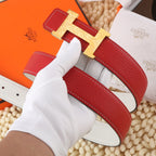 Hermes leather belt with red strap and gold-tone H buckle, shown upright