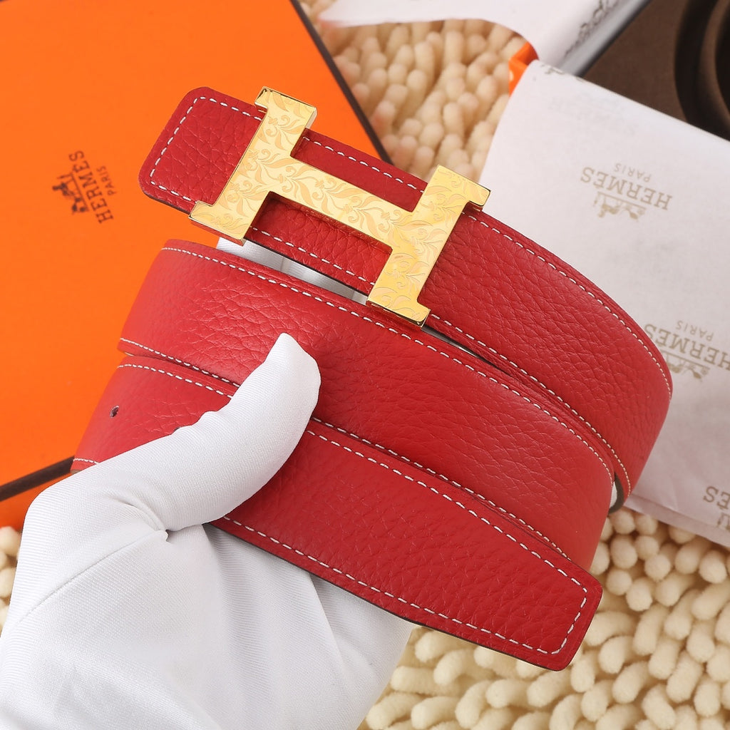 Hermes leather belt with red strap, white stitching, and gold-tone H buckle