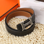Black leather belt with brown lining and silver buckle, rounded view