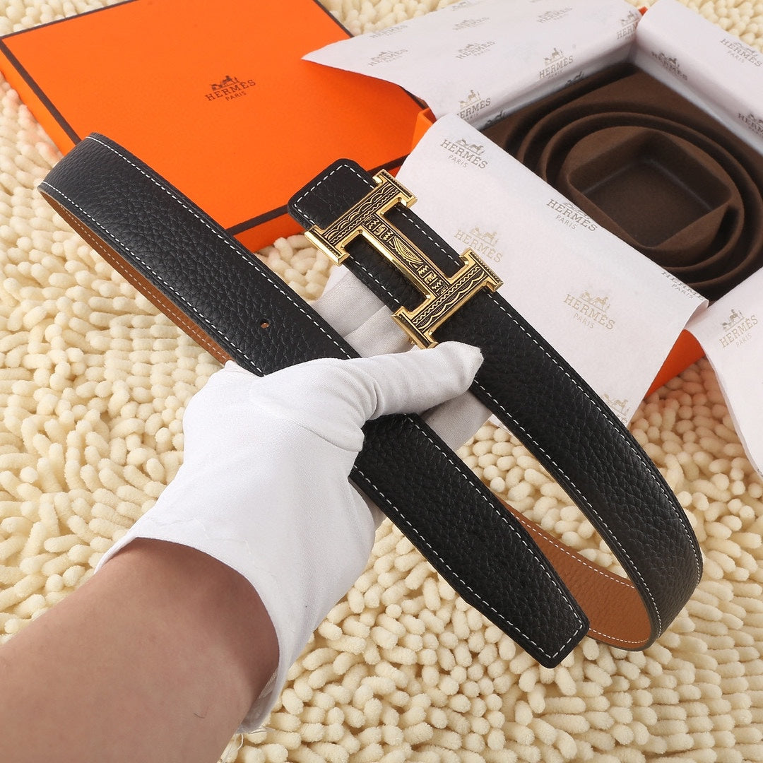 Black leather belt with gold-toned buckle, white-gloved hand holding the strap