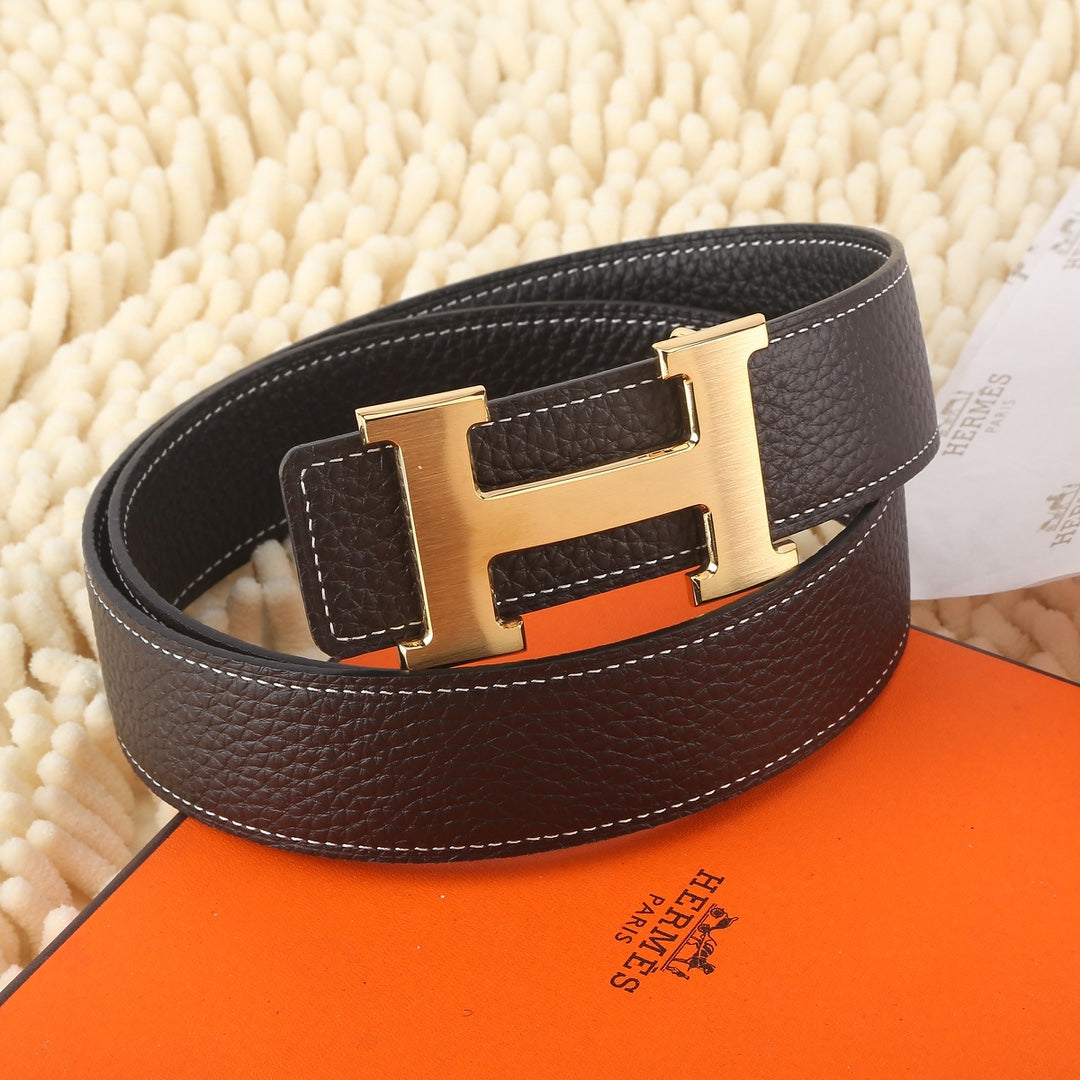 Dark leather belt with gold-tone buckle and white contrast stitching, side view.
