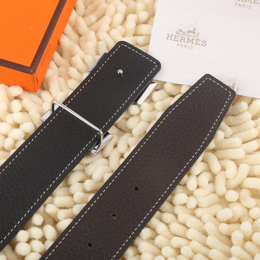 Dark leather belt straps with gold-tone buckle and white contrast stitching, holes visible.