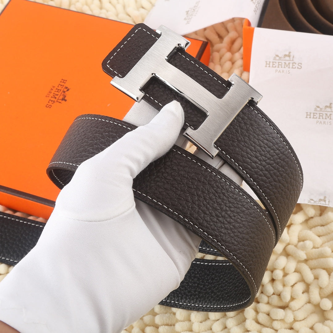 Dark leather belt with gold-tone buckle and white contrast stitching, front angle.