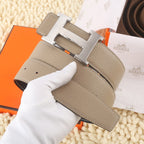 Hermes leather belt, taupe with gold H buckle and rows of stitch lines.