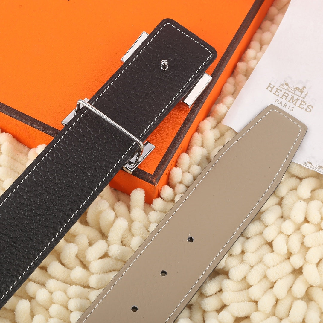 Hermes belt pair view: black and taupe straps with stitched keeper slots.