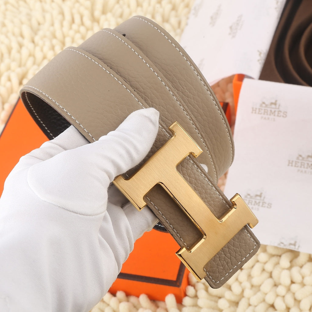 Hermes leather belt, taupe strap with gold H buckle and stitched edges.